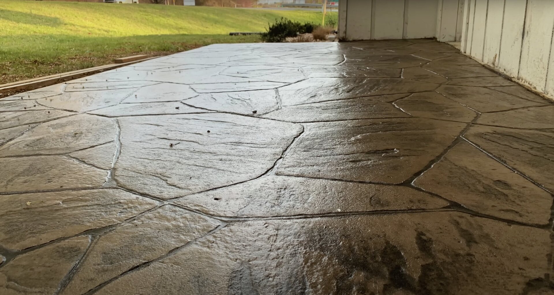 Concrete driveway showing natural aging and maintenance needs Aged concrete driveway showing wear patterns and weathering