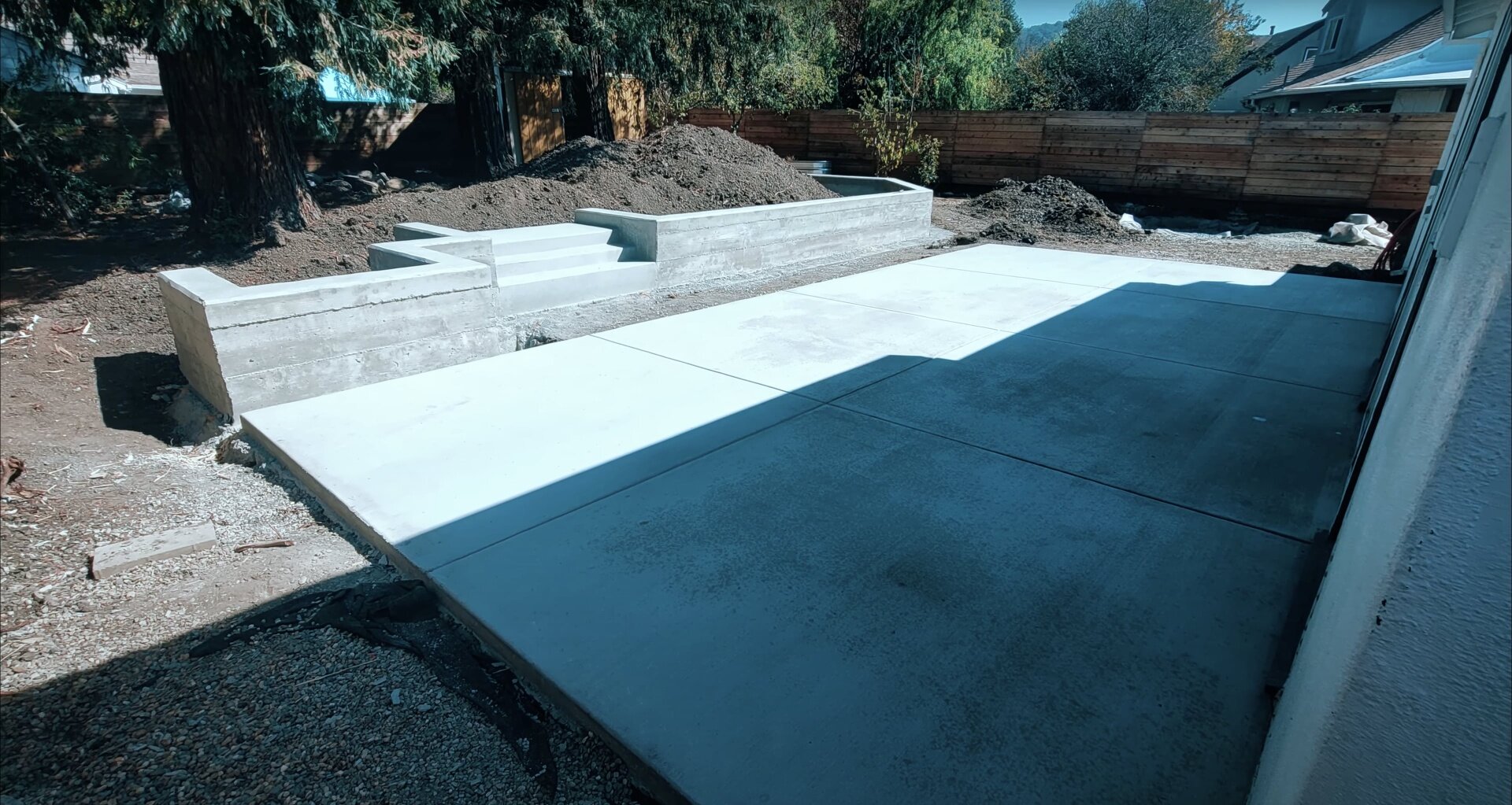 New concrete slab installation with retaining walls and site preparation Fresh concrete slab installation with retaining walls and proper site preparation